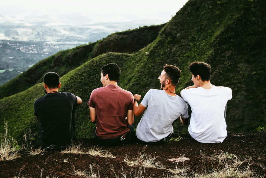 Four Men Sitting On Ground 7 qualities of friendship