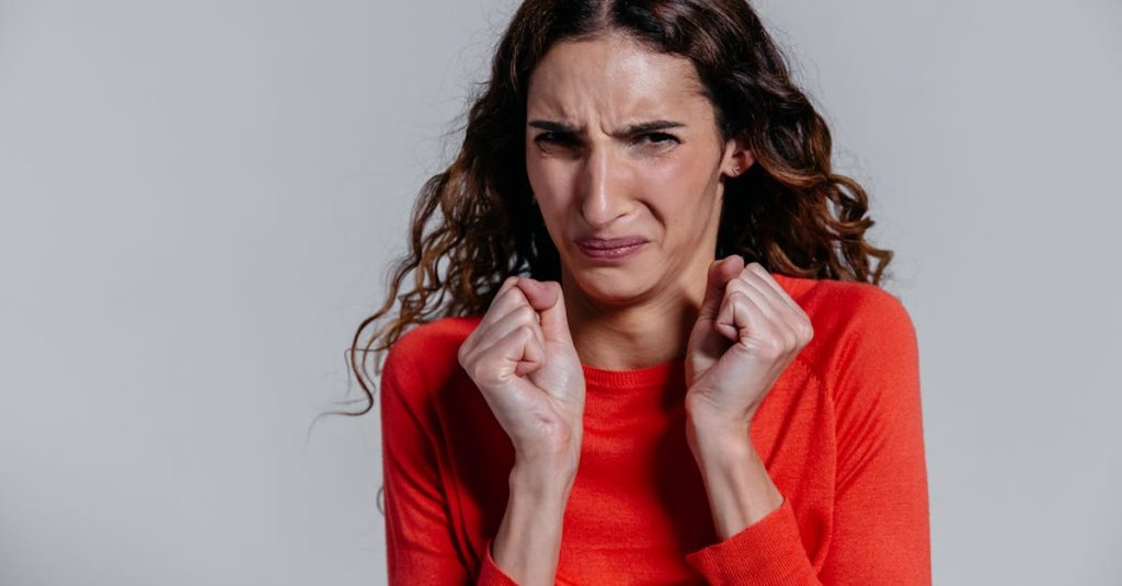 A woman displaying a disgusted facial expression indoors. overcoming contempt